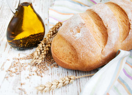 Bread and wheat on a wooden backgroundの写真素材