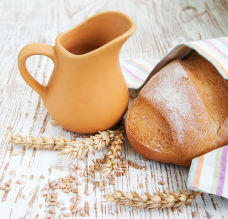 Bread and wheat on a wooden backgroundの写真素材