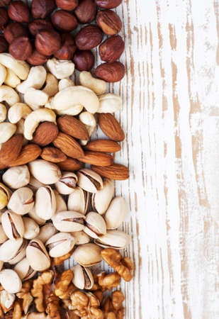 Mixed nuts on a old wooden background - Nuts left side frameの写真素材