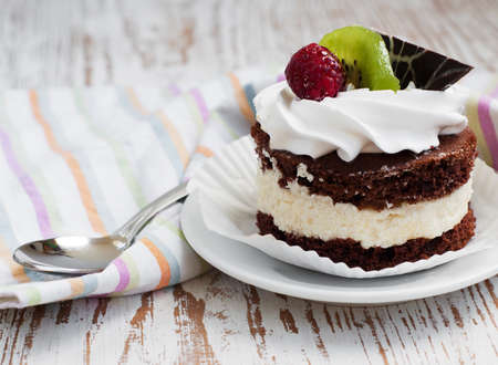 chocolate cake with raspberry and kiwi on a wooden backgroundの写真素材