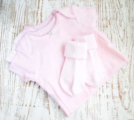 baby  pink apparel on a wooden backgroundの写真素材