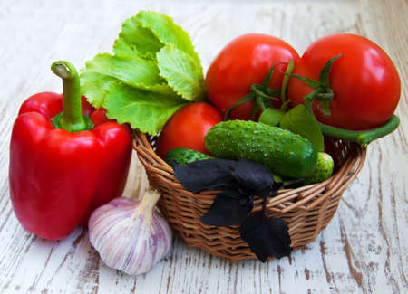 basket  with Fresh vegetables on a wooden tableの写真素材