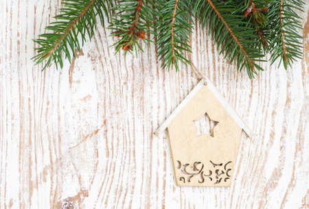 Christmas decoration - Christmas toy and evergreen branch on a wooden backgroundの写真素材