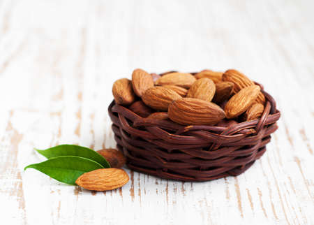 Basket with Almonds on a wooden  backgroundの写真素材