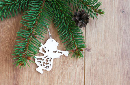 Christmas decoration - Christmas toy and evergreen branch on a wooden backgroundの写真素材