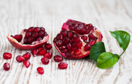 Open pomegranate with seed on wooden の写真素材