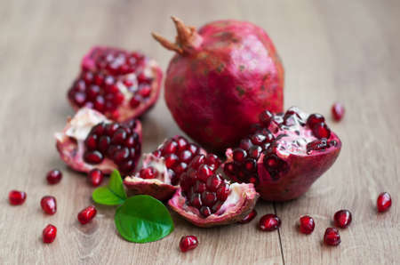 Open pomegranate with seed on wooden backgroundの写真素材