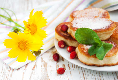 A stack of pancakes and strawberries on a wooden  の写真素材