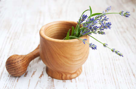 Mortar and pestle with lavender on a wooden backgroundの写真素材