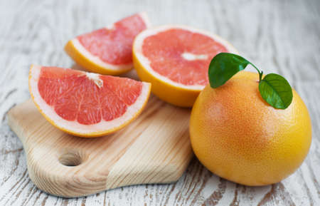 ripe grapefruits with leaves  on wooden  backgroundの写真素材