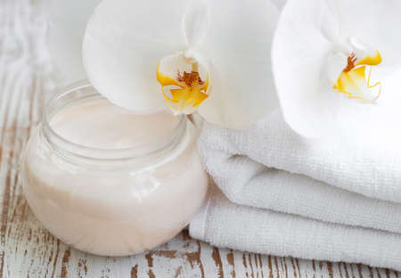 Spa setting with spa towel and white orchidsの写真素材