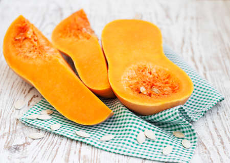 Section of butternut pumpkin on a wooden backgroundの写真素材