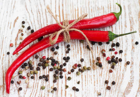 fresh red hot peppers  on a wooden backgroundの写真素材