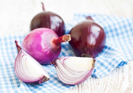 Red onions on a old white wooden tableの写真素材