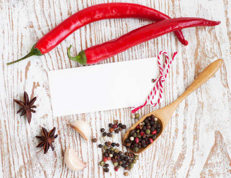 Paper to write recipes on the wooden  background  with spicesの写真素材