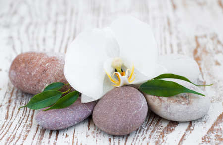 Spa setting with spa stones and white orchidsの写真素材