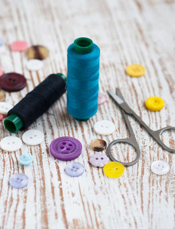 threads, measuring tape on a satin backgroundの写真素材
