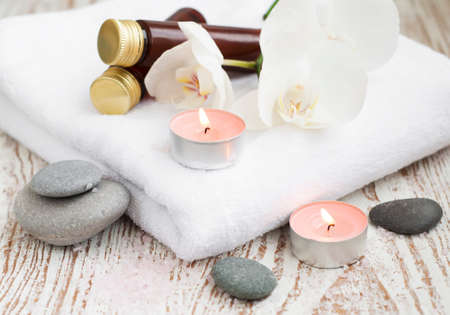 Spa setting with candle, bath salt  and white orchidの写真素材
