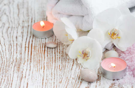 Spa setting with candle, bath salt  and white orchidの写真素材