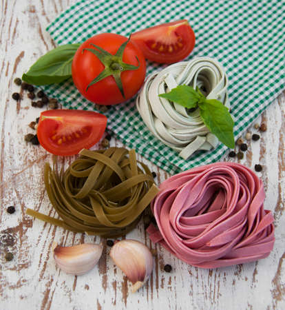 A arrangement of  pasta, garlic, tomatoes    on a wooden  background の写真素材