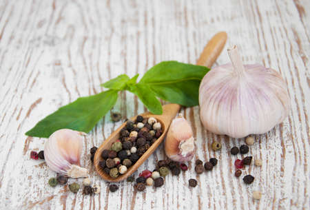 Garlic, basil, peppers on a wooden backgroundの写真素材