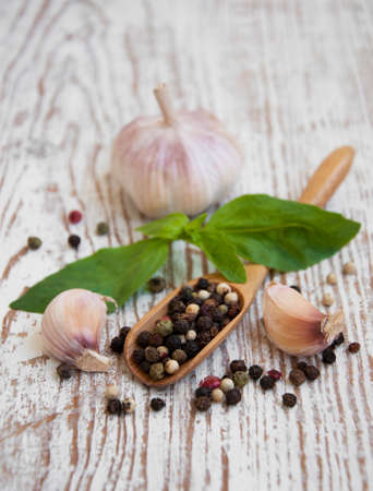 Garlic, basil, peppers on a wooden の写真素材