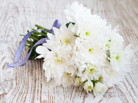 Bouquet of white chrysanthemum on a wooden backgroundの写真素材