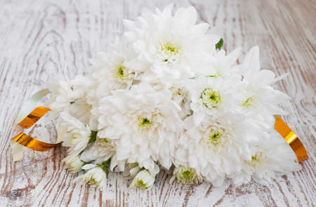 Bouquet of white chrysanthemum on a wooden backgroundの写真素材