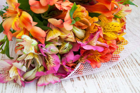 Bouquet of alstroemeria  flowers  on a wooden backgroundの写真素材