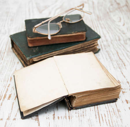 Three very Old Book on a wooden backgroundの写真素材
