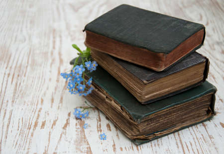 Bunch of forget-me-nots flowers and very old booksの写真素材