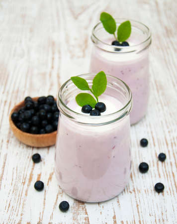 fresh fruit yogurt with blueberries in glass jarの写真素材