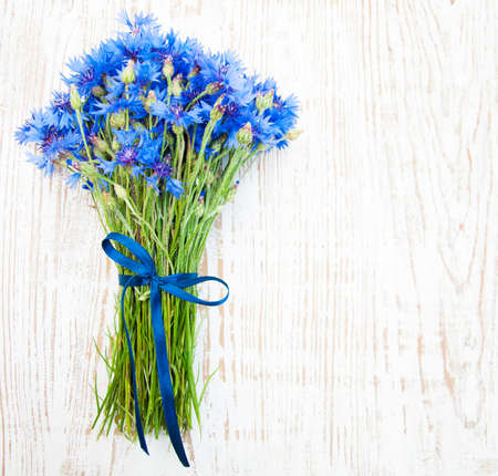 blue cornflowers on a old white wooden  backgroundの写真素材