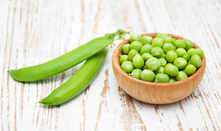 Fresh Garden Peas in a bowl on  wooden backgroundの写真素材