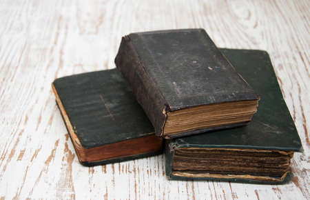 Three very Old Book on a wooden backgroundの写真素材