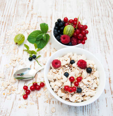 Cereals with fresh fruits on a wooden background