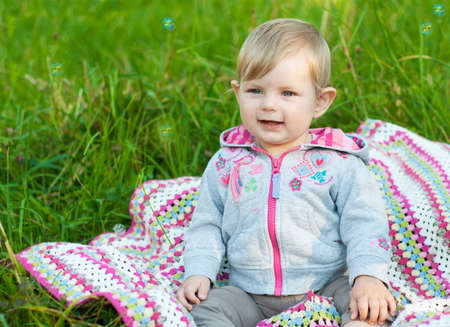 Cute girl with bubbles in the parkの写真素材