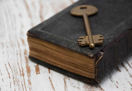Image of old antique book and a big old key.の写真素材