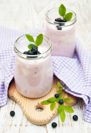 fresh fruit yogurt with blueberries in glass jarの写真素材