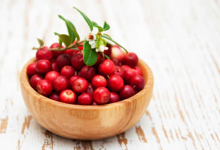 Cranberries with Leaves on a wooden backgroundの写真素材