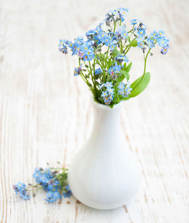 vase with forget-me-nots on wooden table, rustic styleの写真素材