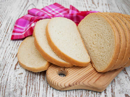 Sliced loaf of bread on a wooden background