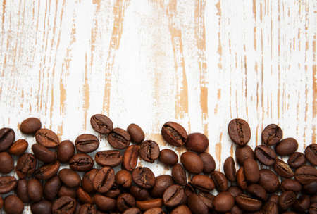 Coffee beans on a old wooden backgroundの写真素材