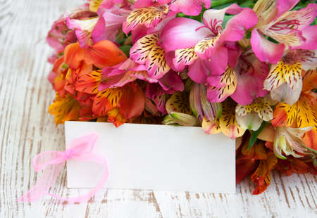 alstroemeria flowers with a white card for a message.の写真素材