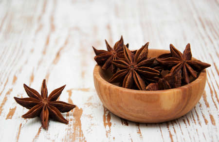 star anise in a bowl on a wooden backgroundの写真素材