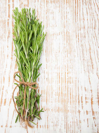 Bunch of rosemary on a wooden backgroundの写真素材