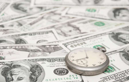 pocket watch on one hundred dollars backgroundの写真素材