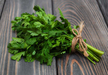 Fresh green coriander on a wooden backgroundの写真素材