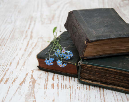 Bunch of forget-me-nots flowers and very old booksの写真素材
