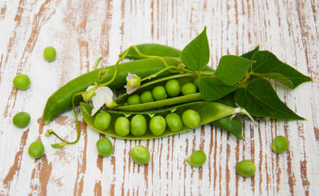 Fresh Garden Peas  on a  wooden backgroundの写真素材